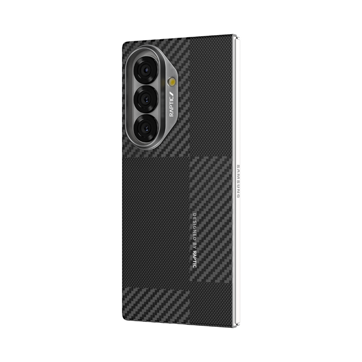 A Samsung Galaxy Fold 7 is shown upright in a black and gray carbon fiber-patterned RAPTIC Aramid Fibre skin case, which features the "RAPTIC" label by the three rear cameras and a silver "SAMSUNG" logo on the right edge for stylish protection.
