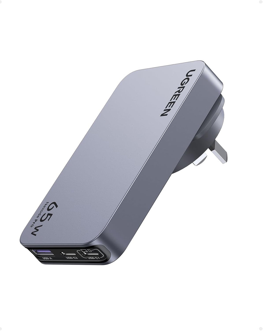 The UGREEN 65W Travel Charger, Nexode Pro 3-Port GaN, features a sleek silver design with foldable plug, USB-C and USB-A ports for fast charging, and displays "UGREEN" branding. Ultra-slim and ideal for travel.