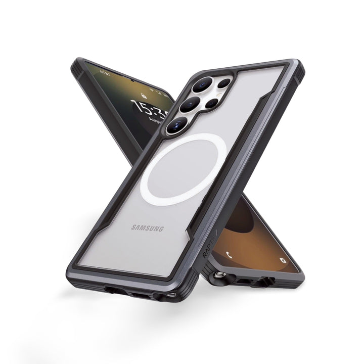 Two Samsung Galaxy S25 phones in clear Raptic Shield cases stand crossed upright. The rugged cases have black edges, a white MagSafe-style ring, and offer military-grade protection. Lock screens display the time on a brown and black background.