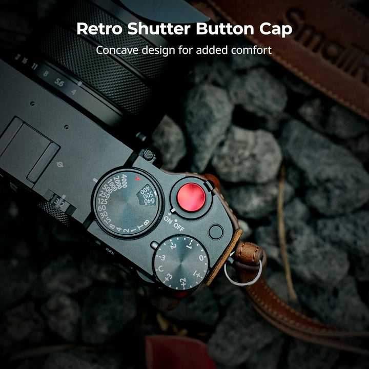 A close-up of a FUJIFILM GFX100RF with the SmallRig GFX100RF Leather Case Kit shows a black camera, brown shoulder strap, and red concave shutter button cap. White text: “Retro Shutter Button Cap. Concave design for added comfort.”.
