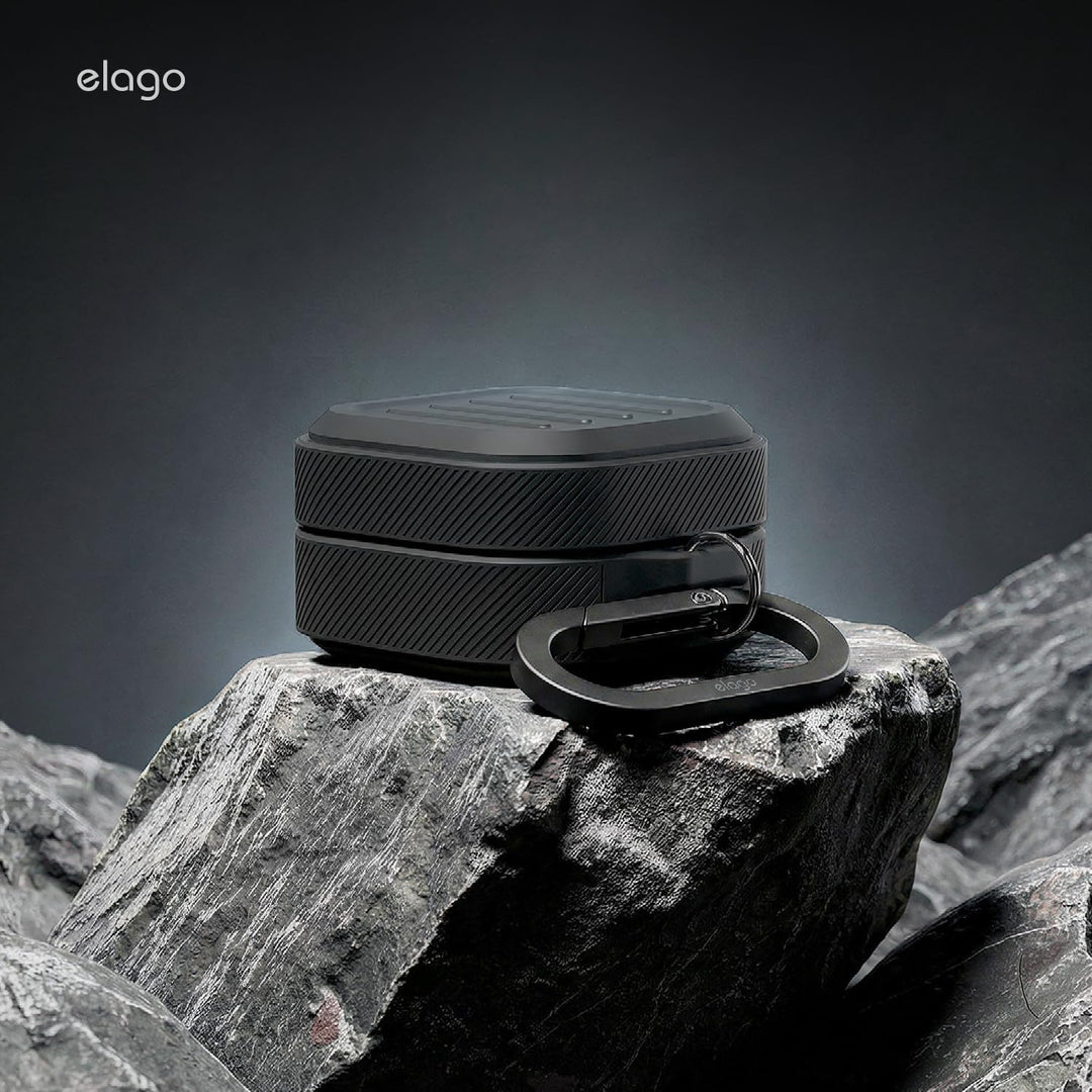 A black MobileTechnica silicone case for Samsung Galaxy Buds 4 Pro & Buds 4 with textured sides and a matching carabiner is shown on rugged gray rock. The carousel features a dark gradient background and the MobileTechnica logo in the top left.