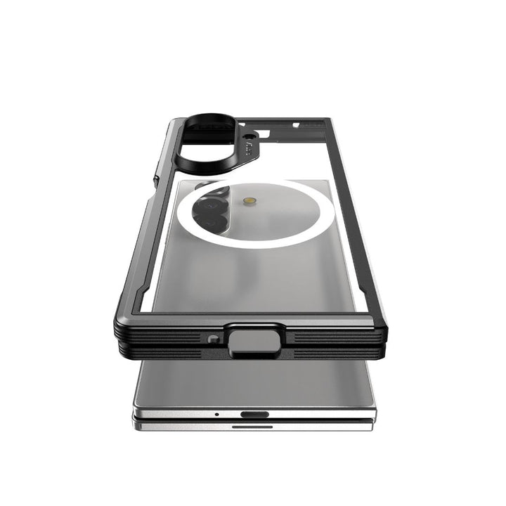 A clear RAPTIC Samsung Galaxy Fold 7 - Raptic Shield Black case with black edges sits above a silver phone, showcasing hinge protection, reinforced corners, raised camera ring, and precise cutouts for modern design and superior protection.