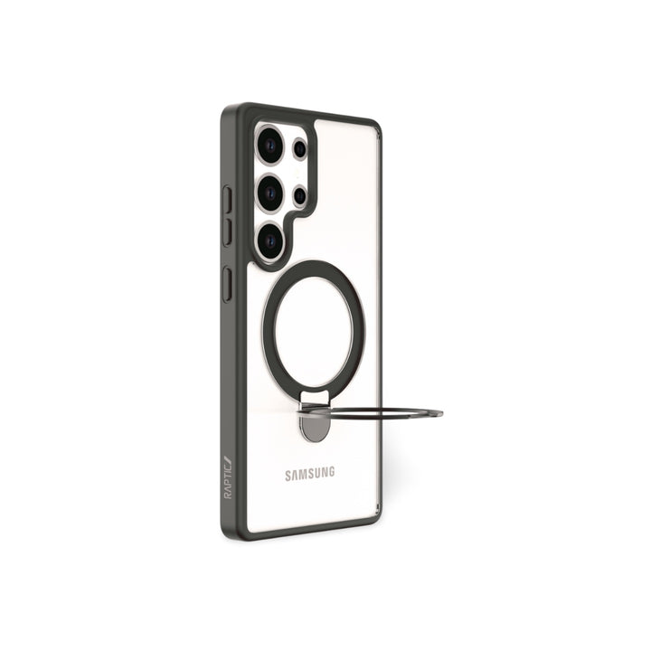 A Samsung S25 in a RAPTIC Air Stand case is shown upright. The clear case with black edges has a built-in metal ring stand on the back for propping up the phone. The rear camera module features four lenses.