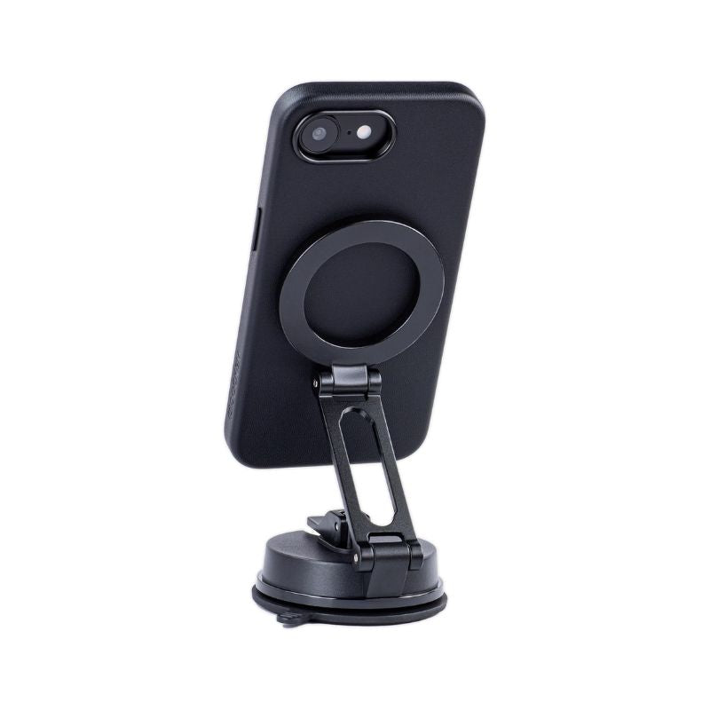 A black Dockem iPhone 16e Synthetic Leather Magnetic Case - Apex MagSafe, with a circular ring holder, is vertically mounted on an adjustable black MagSafe-compatible suction cup stand with a flat base. Plain white background.
