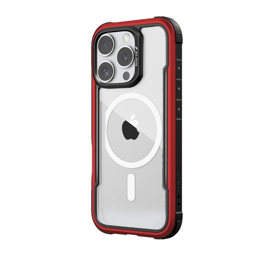 A close-up of the Raptic Shield MagSafe Case for iPhone 16 Pro shows its rugged, wireless charging compatible design. The case boasts a sleek red and black aesthetic with reinforced corners and a clear back revealing the Apple logo. The phone's camera module with multiple lenses is visible at the top left, ensuring drop protection.