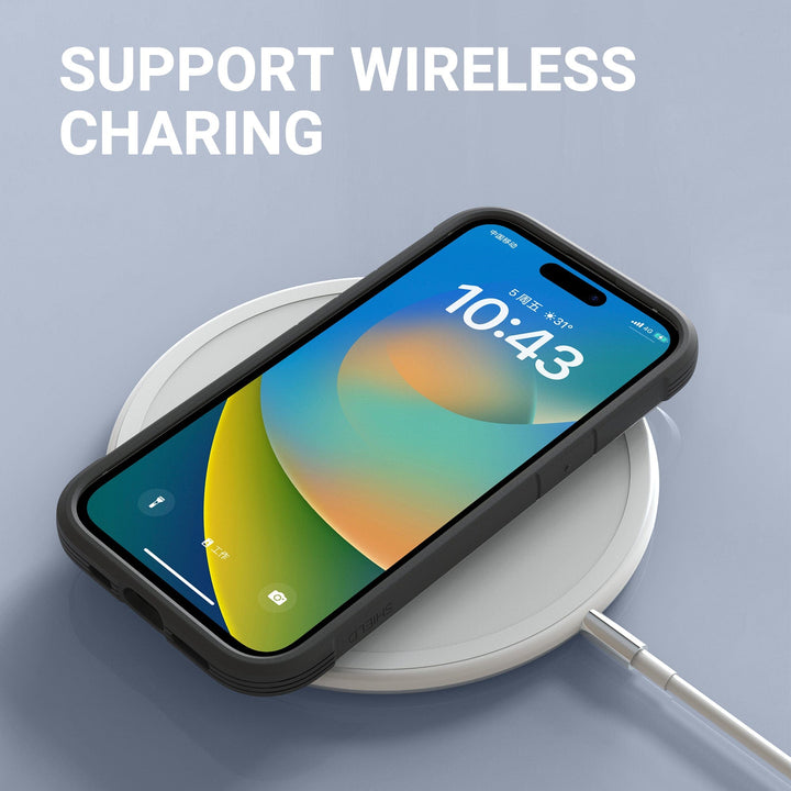 A Raptic Shield MagSafe Case for the iPhone 16 Pro in black is placed on a white wireless charging pad. The screen displays a colorful gradient background with the time "10:43" prominently shown. Above, white text reads "SUPPORT WIRELESS CHARGING." The drop-protection charging pad is connected by a white cable.