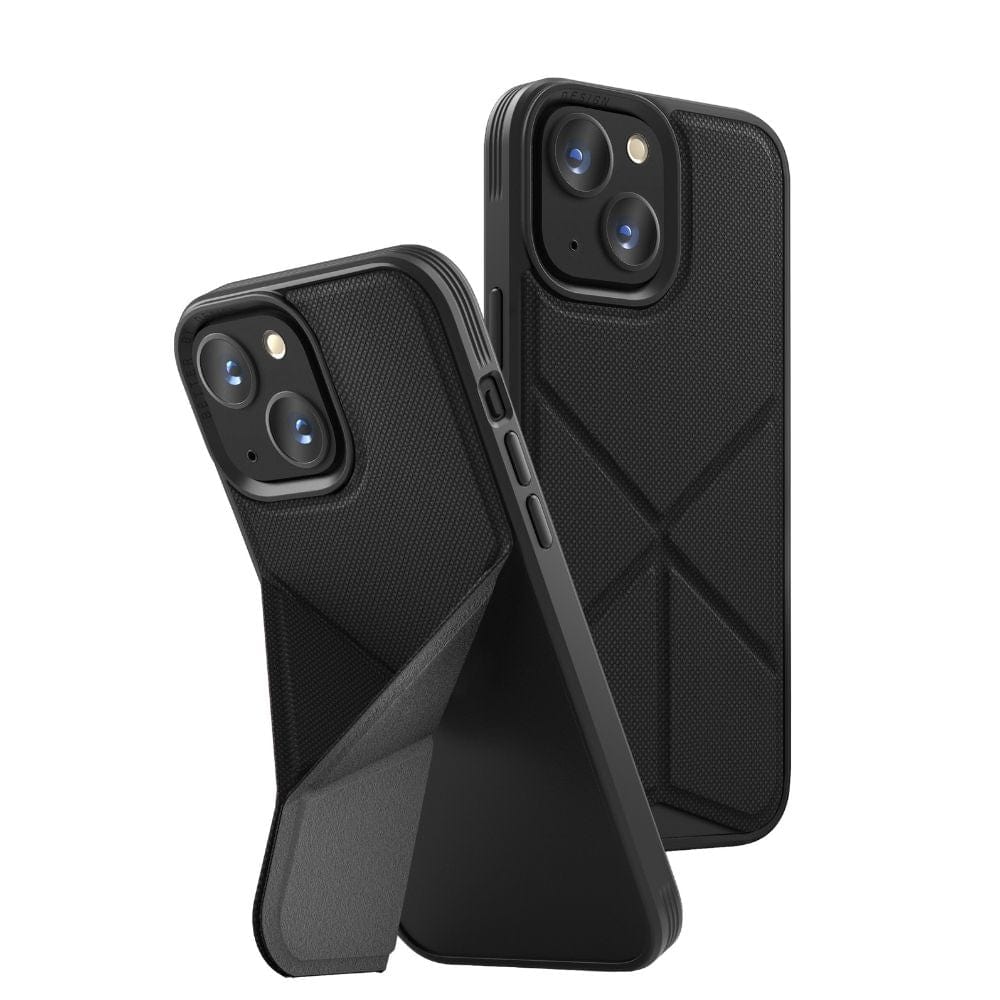 Two iPhone 13 UNIQ Transforma MagSafe Folding Cases in black are displayed. One case is shown standing upright with the attached kickstand extended for hands-free viewing, while the other case is positioned at an angle showcasing the back and side. Both cases feature a textured pattern with precise openings for camera lenses and buttons, ensuring reliable drop protection.