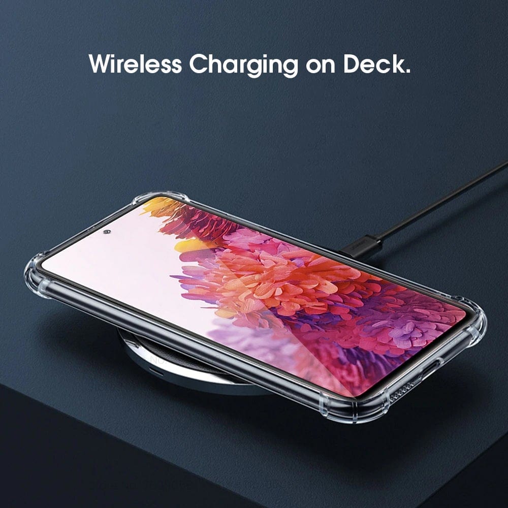 An Urban Samsung Galaxy S23 FE Clear Case encloses the phone, which is placed on a wireless charging pad with the text "Wireless Charging on Deck." visible above.